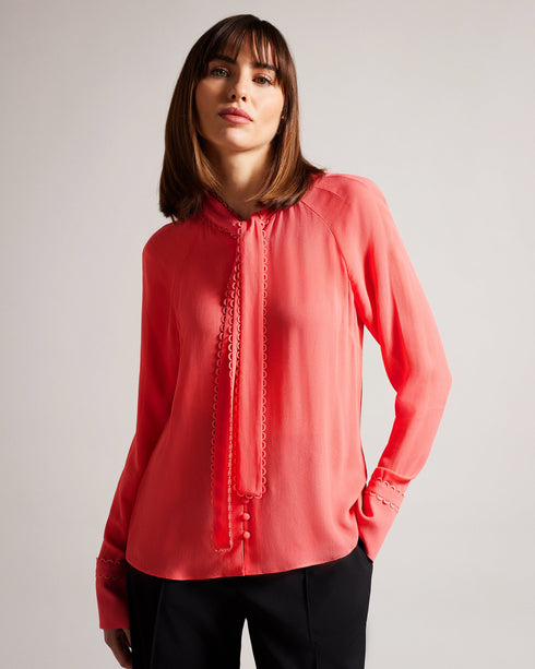 JULINAA-Tops-JULINAA is a lightweight, feminine layer that transitions easily from day to evening. This lightweight blouse pairs wonderfully with wide-leg trousers and heels for a polished office look—or switch it up for jeans and sandals on a sunny weekend getaway. Blouse Neck tie Looped rouleaux trim Long sleeved Button fastening Lightweight fabric Julia is 5'10" / 1.78m and wears Coral in a Ted size 1- Ted Baker Romania